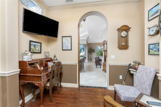 interior space featuring plenty of natural light, dark hardwood / wood-style flooring, and crown molding