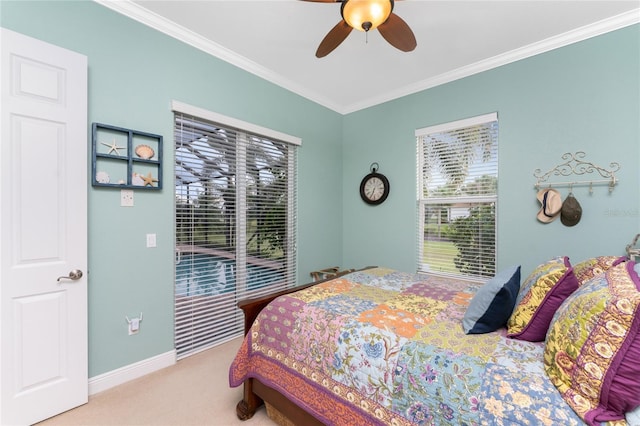 carpeted bedroom with ceiling fan and ornamental molding