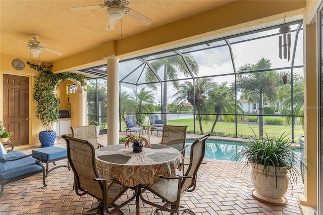 sunroom / solarium featuring a pool and ceiling fan