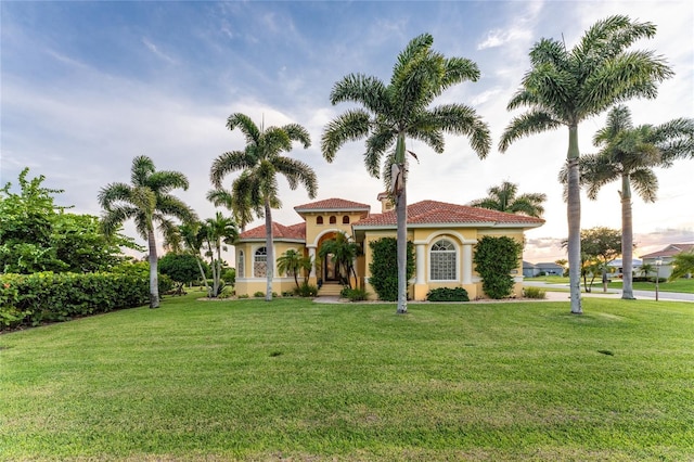 mediterranean / spanish-style home with a front yard