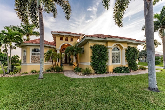 mediterranean / spanish-style house featuring a front yard