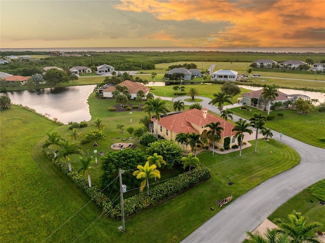 aerial view at dusk with a water view