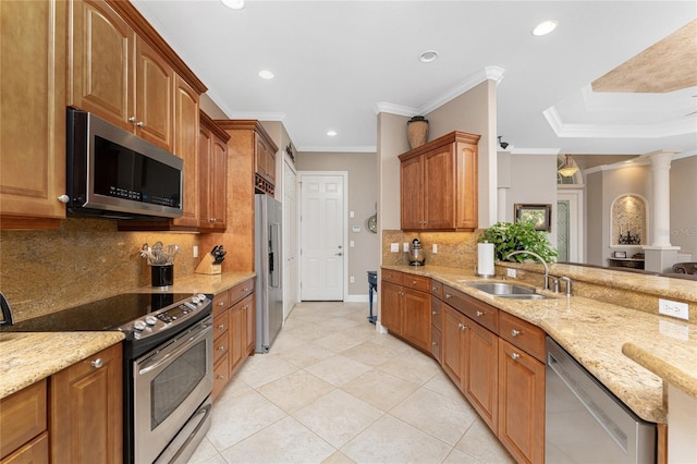 kitchen with ornamental molding, appliances with stainless steel finishes, sink, and light stone counters