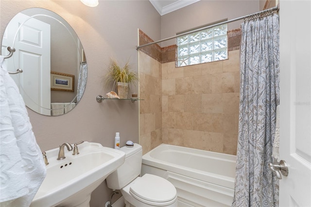 full bathroom featuring sink, ornamental molding, shower / bath combination with curtain, and toilet