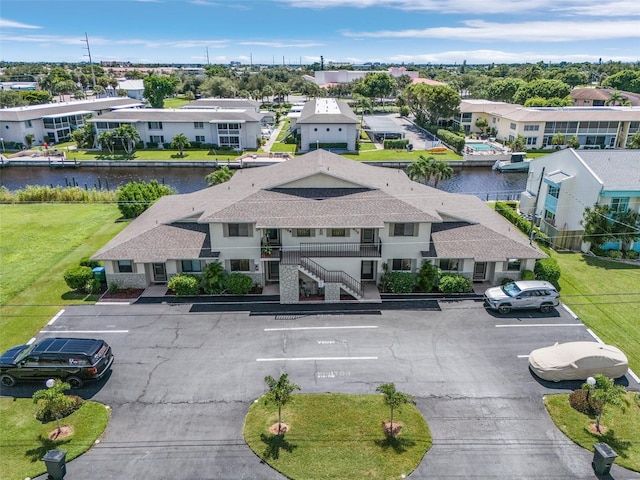 birds eye view of property with a water view and a residential view