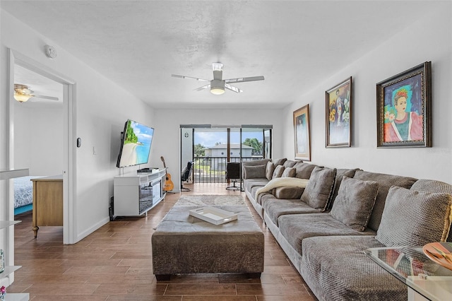 living room featuring ceiling fan and wood-type flooring