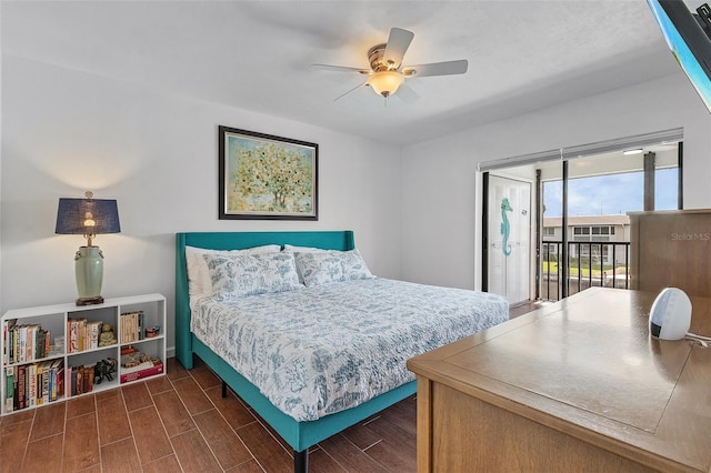 bedroom with ceiling fan, access to exterior, and dark wood-type flooring