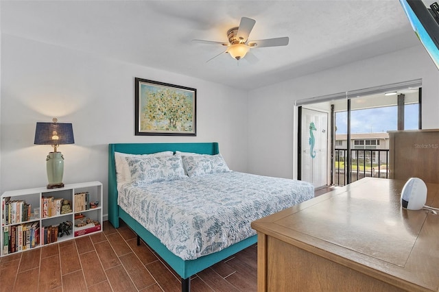 bedroom with a ceiling fan, access to exterior, and wood finished floors