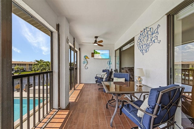 sunroom featuring ceiling fan