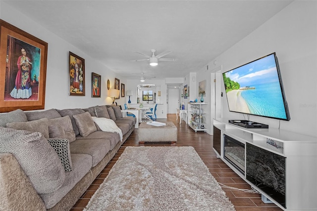 living room featuring ceiling fan and dark hardwood / wood-style floors