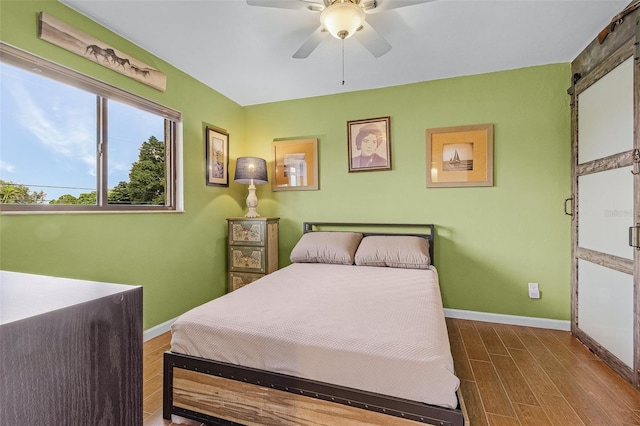 bedroom with hardwood / wood-style floors and ceiling fan