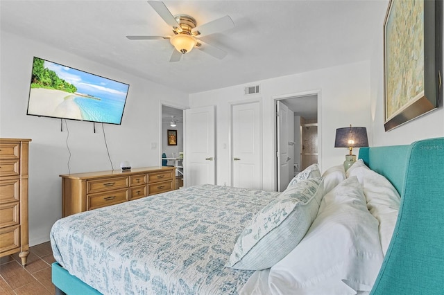 bedroom with ceiling fan, visible vents, and dark wood-style floors