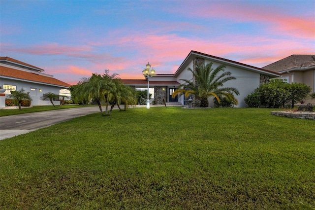 view of front of property featuring a yard and a garage