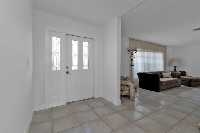 foyer entrance with light tile patterned floors