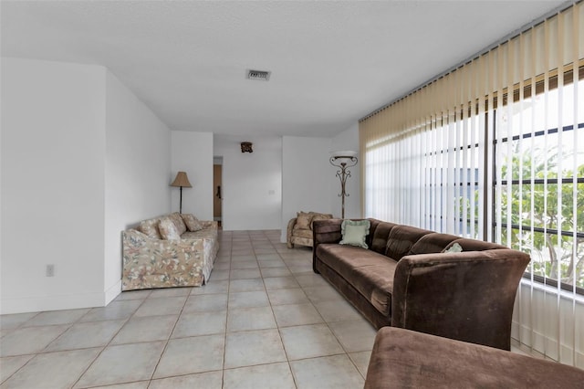 tiled living room with plenty of natural light