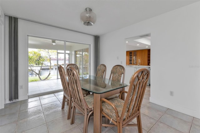 dining room featuring sink and light tile patterned floors