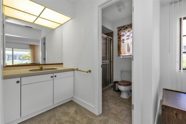 bathroom with vanity, a shower with shower door, and toilet