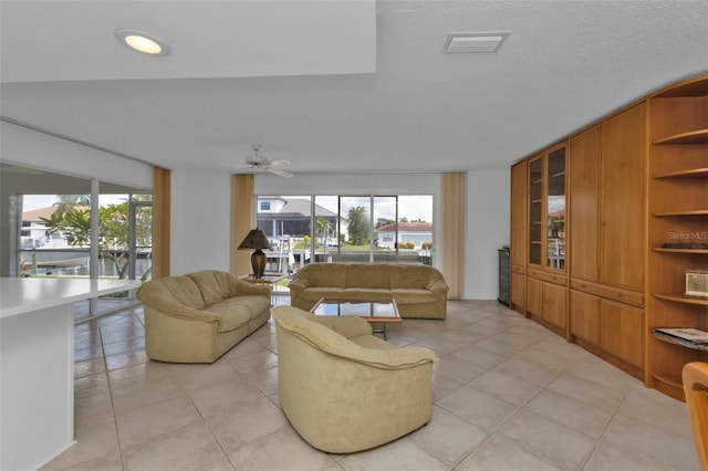 living room featuring ceiling fan and light tile patterned flooring