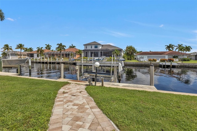 dock area featuring a lawn and a water view