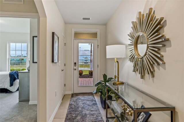 entryway featuring light colored carpet