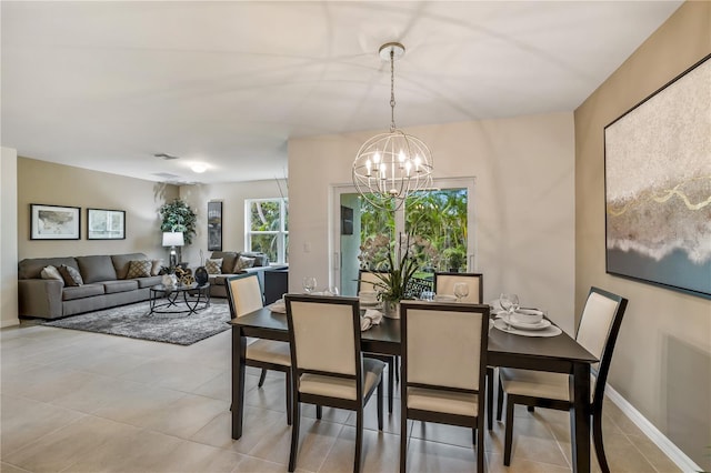 dining space with an inviting chandelier and light tile patterned flooring