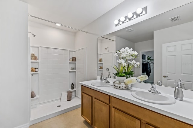 bathroom with vanity and a shower