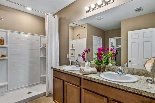 bathroom featuring curtained shower, tile patterned flooring, and vanity