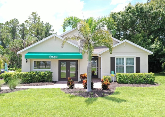 single story home featuring a front lawn and french doors