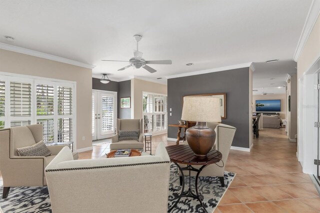 living room featuring ceiling fan, light tile patterned floors, crown molding, and french doors