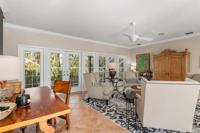 tiled living room featuring crown molding, ceiling fan, a wealth of natural light, and french doors