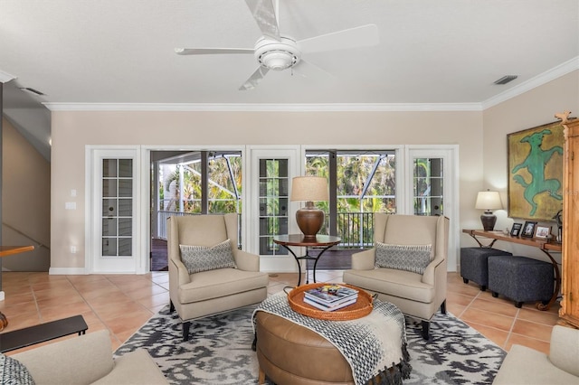 living room with ceiling fan, crown molding, a healthy amount of sunlight, and light tile patterned flooring