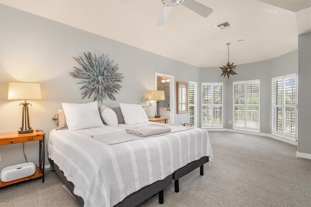 bedroom featuring ceiling fan with notable chandelier, multiple windows, connected bathroom, and carpet flooring