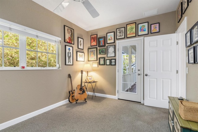 miscellaneous room featuring ceiling fan, plenty of natural light, and carpet