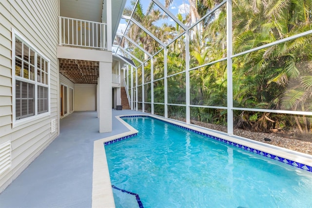 view of pool with a lanai and a patio