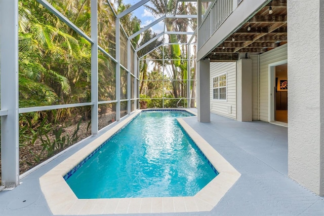 view of swimming pool with a lanai and a patio