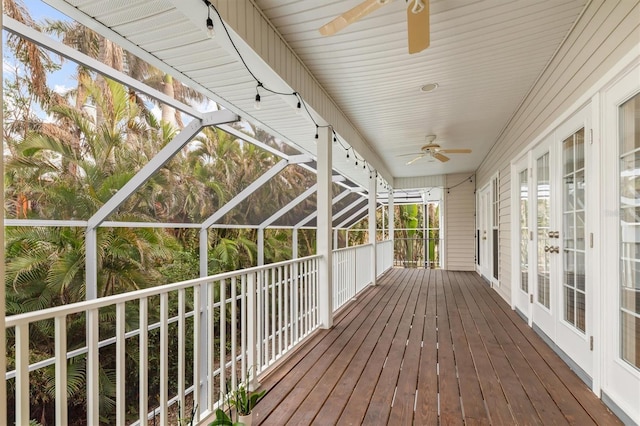 deck featuring a lanai, ceiling fan, and french doors