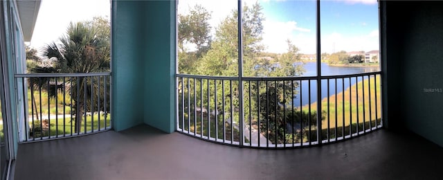 unfurnished sunroom featuring a water view