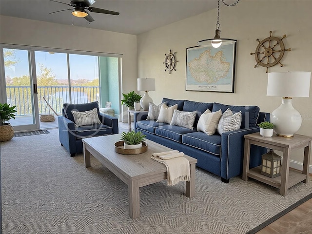 living room featuring a ceiling fan and carpet floors