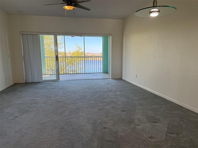 empty room featuring carpet, baseboards, ceiling fan, and a textured wall