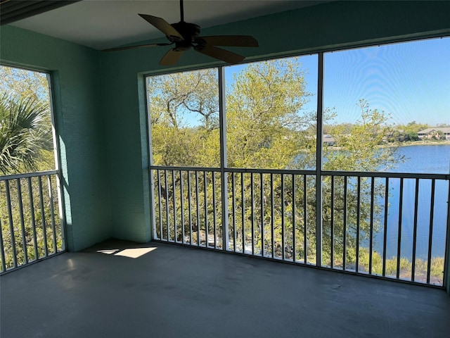 unfurnished sunroom with a water view