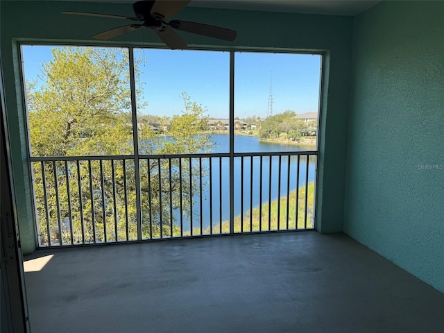 unfurnished sunroom featuring a water view