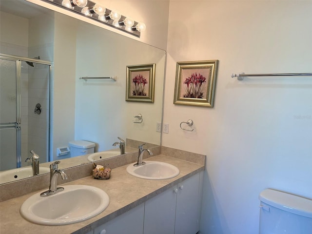 full bathroom featuring a sink, toilet, and a shower stall