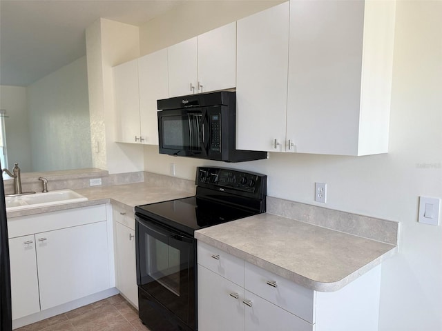 kitchen featuring white cabinets, light countertops, a sink, and black appliances