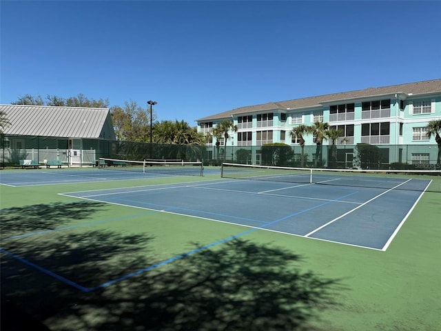 view of sport court featuring fence