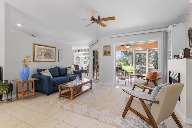 tiled living room featuring ceiling fan