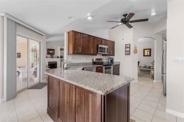 kitchen with appliances with stainless steel finishes, kitchen peninsula, lofted ceiling, ceiling fan, and sink