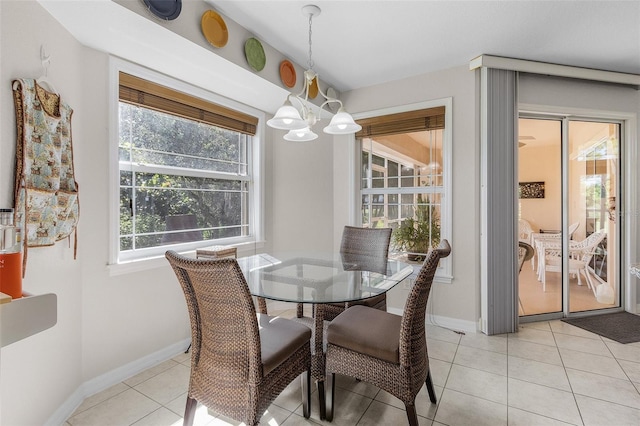 tiled dining space with a chandelier