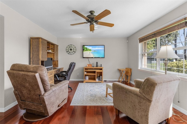 living room featuring ceiling fan and dark hardwood / wood-style flooring