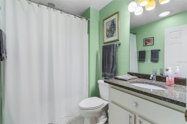 bathroom with vanity, toilet, and tile patterned floors