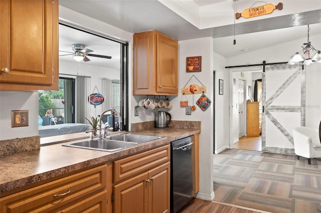 kitchen featuring hanging light fixtures, a barn door, dishwasher, ceiling fan, and sink